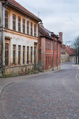 Old city street with old stone and wooden facades and stone paving road