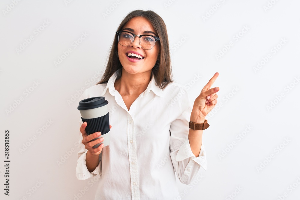 Wall mural Young businesswoman wearing glasses drinking coffee over isolated white background very happy pointing with hand and finger to the side - Wall murals