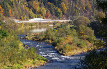 Fototapeta na wymiar Poprad River in Autumn. View from hamlet Kace, Slovakia.