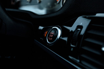 Obraz na płótnie Canvas Closeup of a modern car interior with Start Stop engine button