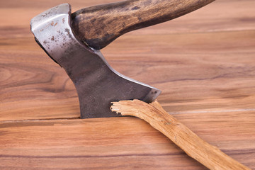 Old ax on a wooden background. Wooden hilt.