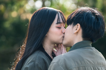 Fototapeta premium A couple of gay woman holding hands each other and kissing. Moments Happiness Concept