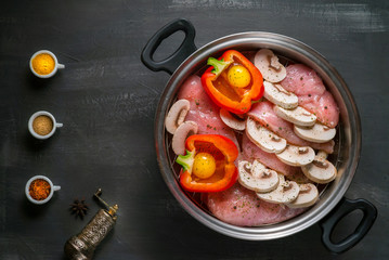 healthy food dish with raw chicken before steaming with mushrooms and vegetables on a black background 4k