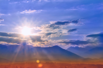 Bright dawn over the mountain peaks, beauty and purity of nature. Light-filled dawn in the mountains. Faith, hope, love, joy, victory, luck, strength, success