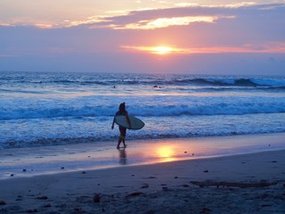 surfer walking in the sunset