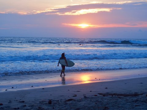 surfer walking in the sunset