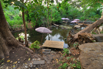 Cafe with Thai style wooden tables in the waterfall.
