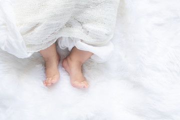 Cute newborn baby girl in white blanket on nursery bed. Adorable new born child, little boy...