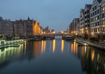 Obraz premium Night view of the old part of the city. Gdansk, Poland. Green bridge, ancient beautiful building and Motlawa river