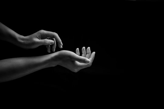 Cropped Hands Of Woman Against Black Background