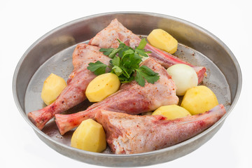 Lamb shank kebab on tray and potato onions around