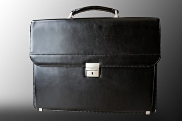 black leather briefcase isolated on black and white background