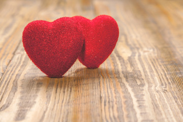 Fototapeta premium Two red hearts on wooden background