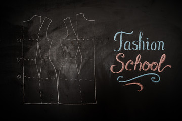 Fototapeta premium Fashion school. Drawing of a pattern on a blackboard in a design studio for sewing and tailoring, special education concept, place for insertion