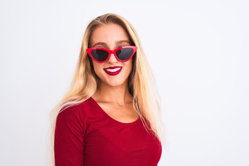Young beautiful woman wearing red t-shirt and sunglasses over isolated white background with a happy and cool smile on face. Lucky person.