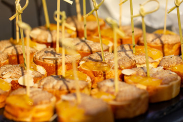 Canapes with white bread, pate and honey. Selective focus.