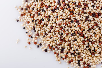 mix of quinoa grains on white acrylic background