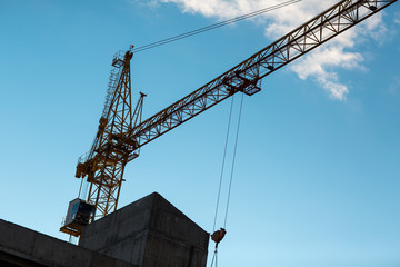 Building construction house with crane concept. Blue sky background.