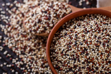 mix of quinoa grains on dark wooden rustic background