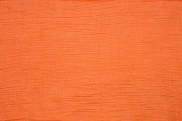 Background elastic viscose fabric of coral color. Backgrounds, textures, design.