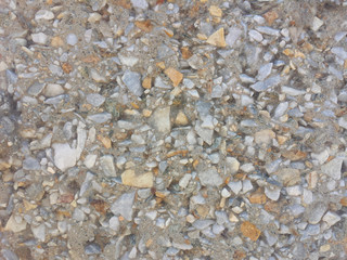 Cement wall with small stones texture closup background