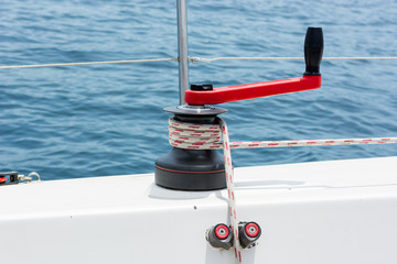 Hand winch on a sailboat while sailing.