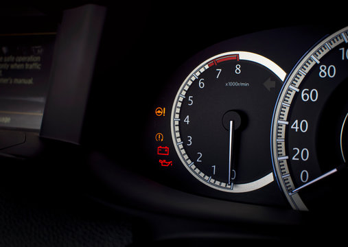 Rpm gauge and warning light such as electric steering,battery,engine oil lubricant on a mileage dashboard in a luxury car,automotive part concept.