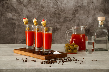 Bloody Mary Cocktail Bar with a variety of side dishes. Bloody Mary tomato juice with vodka olives lemon and pepper on a gray background.