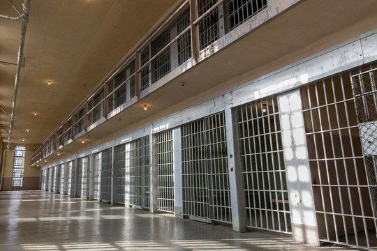 wide angle view of Jail or prison bars being lit up by the sun