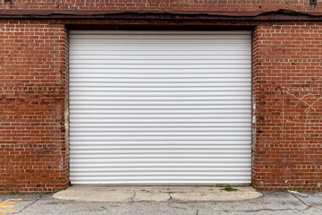red brick wall warehouse shipping receiving door delivery roll up door alley entrance 