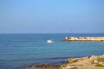 Molo del porto sul mare mediterraneo e piccola barca