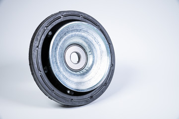 New thrust bearing of front suspension strut of a car on a gray background. The concept of new spare parts and replacement parts in service centers
