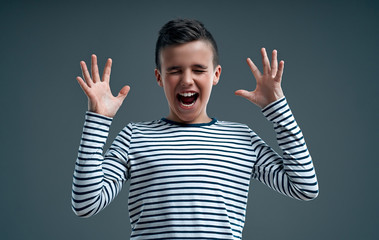 Fashionable boy on a gray background