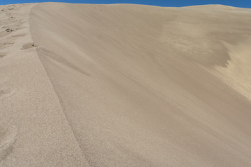 Giant sand dune landscape with clear blue sky