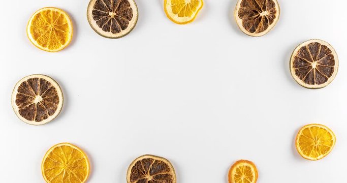 creative and bright minimalistic flat lay composition with sliced limes and lemons on white background, citrus fruits making a frame, moving and rotating, food concept of healthy eating and dieting