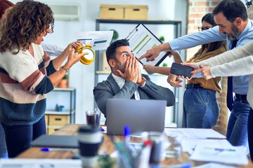Group of business workers working together. Partners stressing one of them at the office
