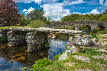Fototapeta na wymiar Medieval clapper bridge over the East Dart River at Postbridge on Dartmoor in Devon, West Country, England, UK
