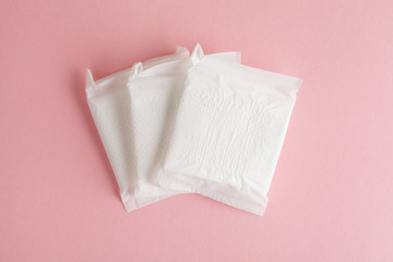 menstruation cycle, feminine hygiene and protection, sanitary pads on pastel pink background, top...