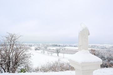 Statue on a waycross in Burgenland with snow
