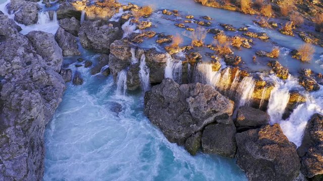 Frothy water in cascades and whitewater rapids at the waterfall Niagara on Cijevna (Cem) river near Podgorica and Tuzi in Montenegro, after heavy rains in wet season, at sunset. Aerial panning shot.