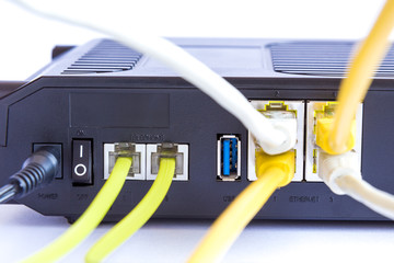 Backside view of dual band wifi router with cat-6 and phone cables connected to the modem. Internet...