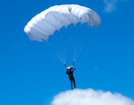 Humorous picture - a skydiver standing on a cloud.