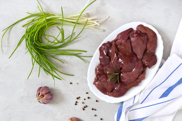 Raw chicken liver in a bowl on the table. Offal. Ready to cook. Top view. Dishes from the liver. The top view