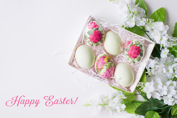 Easter card. Eggs with a floral pattern on a white background with flowers in the decoupage technique. Space for text.
