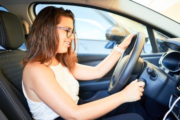 Fototapeta na wymiar Young driver woman driving car