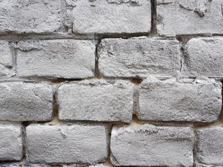 Old red brick wall with damaged white paint layer, closeup background photo texture. Seamless composition