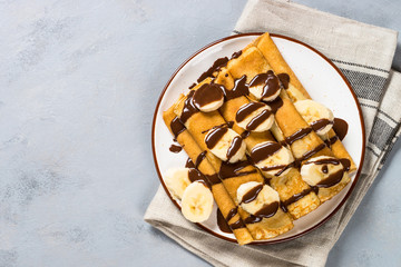 Crepes with chocolate and banana top view.