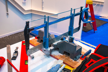 Naklejka premium Equipment for the laying of cable channels. Cable channel cutting machine. Installation of plastic boxes for wires. Tool for cutting cable channels.