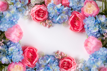 Flower frame, banner. Postcard with blue and pink flowers: hydrangea, peonies on a white background. Space for text