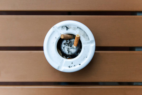 Close-Up Of Cigarette In Ashtray At Table